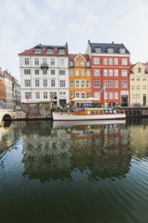 Moored boat and colourful 17th century apartment buildings and houses along the Nyhavn canal,