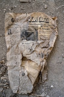 Remains of an old Kyrgyz newspaper from 1924 with Cyrillic writing in an abandoned building, ghost