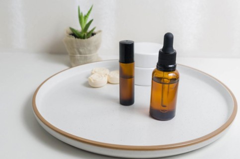 Cosmetic packaging. Set of different cosmetics on plate with decoration. Skin care concept