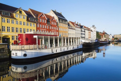 Moored Liva II restaurant boat, ships and colourful 17th century apartment buildings and houses