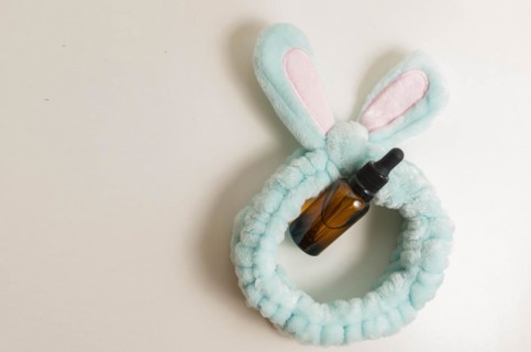 Cosmetic packaging. Set of different cosmetics on plate with decoration and bunny headband