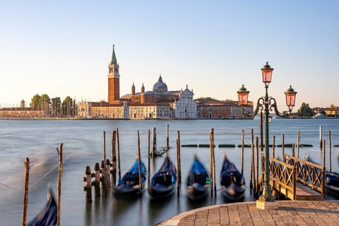 Venetian gondolas, boat dock at St Mark's Square, church of San Giorgio Maggiore in the background,