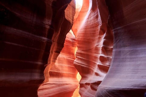 Rock arch in the canyon illuminated from above creates a soft play of light and shadow, Upper