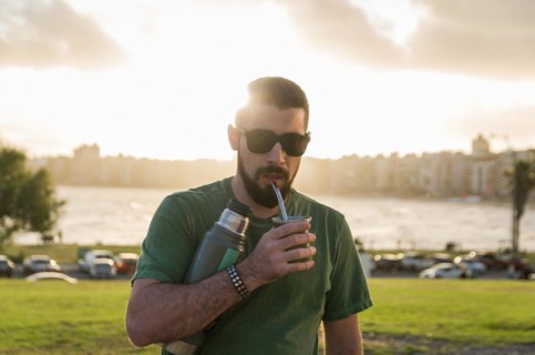 Man drinking chimarrao, mate tea tea (an infusion of yerba mate tea tea with hot water) at sunset