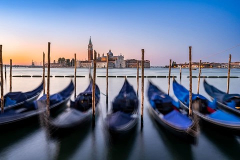 Venetian gondolas, boat dock at St Mark's Square, church of San Giorgio Maggiore in the background,