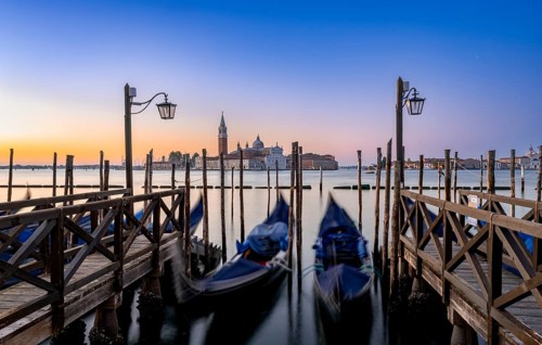 Venetian gondolas, boat dock at St Mark's Square, church of San Giorgio Maggiore in the background,