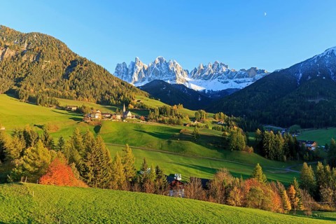 Idyllic landscape with village surrounded by meadows and a mountain panorama, Italy, Trentino-Alto