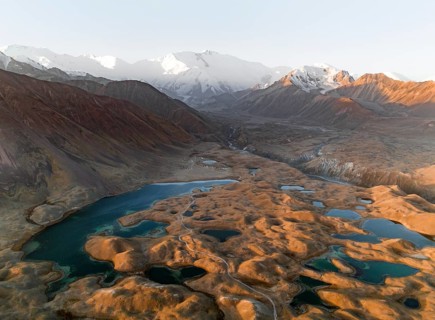 Aerial view, high mountain landscape with glacial moraines and mountain lakes, behind Pik Lenin,