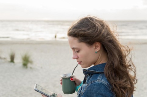 Beautiful young woman drinking Chimarao, mate tea tea (yerba mate tea tea infusion drink) on the