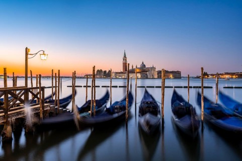 Venetian gondolas, boat dock at St Mark's Square, church of San Giorgio Maggiore in the background,
