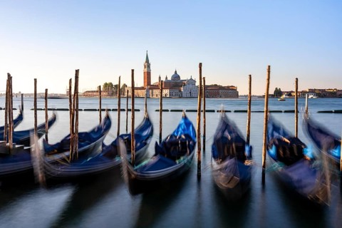 Venetian gondolas, boat dock at St Mark's Square, church of San Giorgio Maggiore in the background,