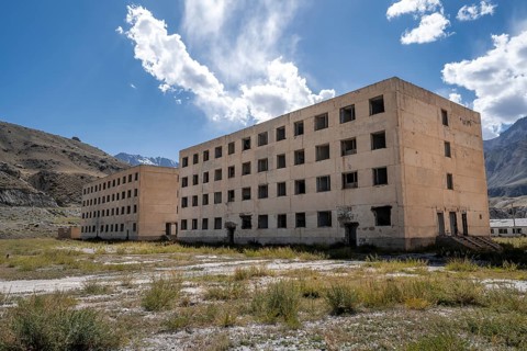 Abandoned, destroyed residential buildings, old Soviet apartment blocks in the ghost town,