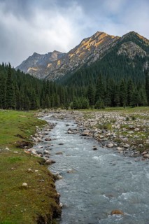 Green mountain valley with river and steep mountain peaks, Chong Kyzyl Suu Valley, Terskey Ala Too,