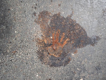 Handprint on the asphalt, after removal of a climate sticker, Leoben, Styria, Austria, Europe