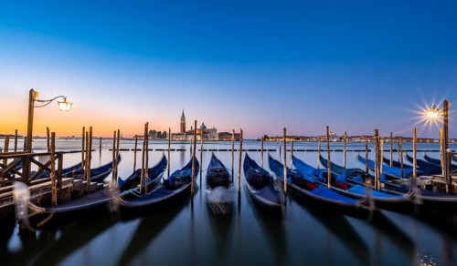 Venetian gondolas, boat dock at St Mark's Square, church of San Giorgio Maggiore in the background,