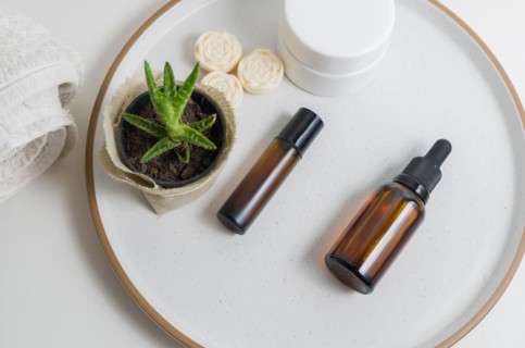 Cosmetic packaging. Set of different cosmetics on plate with decoration. Skin care concept