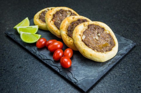 Delicious Lebanese (Arabic) food, genuine sfihas on a slate plate with tomatoes and lemons