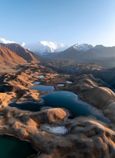 Aerial view, high mountain landscape with glacial moraines and mountain lakes, behind Pik Lenin,