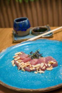 Delicious premium tuna sashimi arranged on an elegant handmade platter