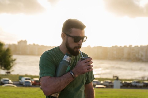Man drinking chimarrao, mate tea tea (an infusion of yerba mate tea tea with hot water) at sunset