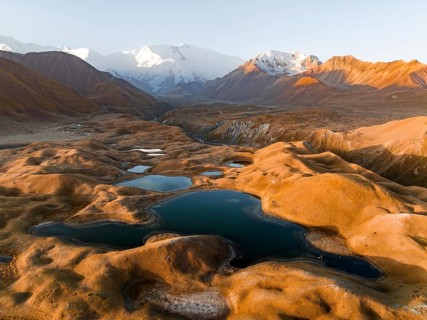 Aerial view, high mountain landscape with glacial moraines and mountain lakes, behind Pik Lenin,