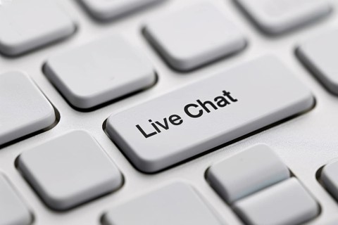 Close up of live chat key on white keyboard. Close up of wind mill turbine covered in ic ein