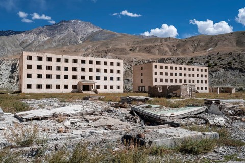 Abandoned, destroyed residential buildings, old Soviet apartment blocks in the ghost town,