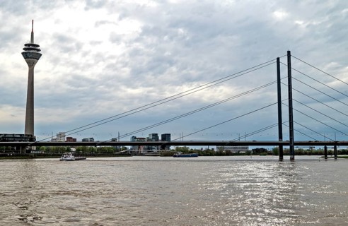 Rheinpromenade, view of Rheinkniebruecke, and Rheinturm Duesseldorf, North Rhine-Westphalia,