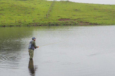 Black bass fisherman fishing inside lake, Cambara do sul, Rio Grande do sul, Brazil, South America