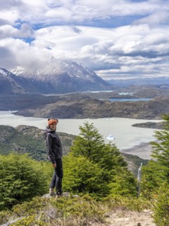 Young woman standing in front of Lago Grey, Hike to Ferrier lookout, Torres de Paine, Magallanes