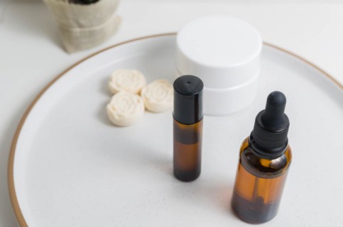 Cosmetic packaging. Set of different cosmetics on plate with decoration. Skin care concept