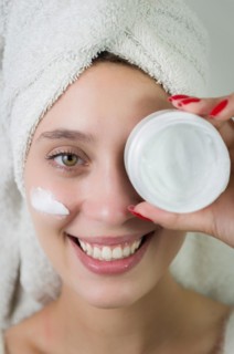 Skincare, product and woman with cream on face, and excited advertising luxury skin care promotion.