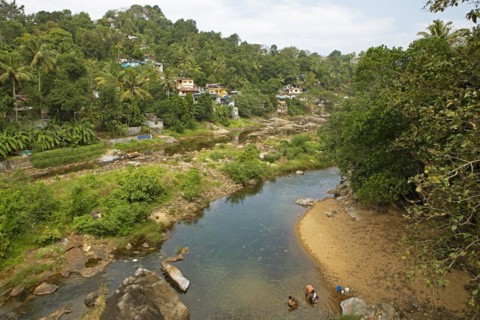 Indian people washing clothes in the Periyar River, Mundakayam, Kerala, India, Asia