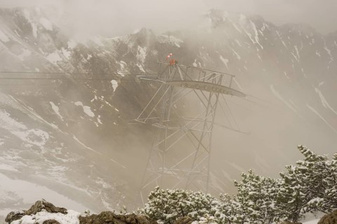 Cable car technicians working in bad weather conditions, Nebelhorn cable car near Oberstdorf,
