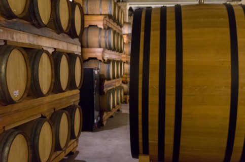 Oak barrels for wine aging in an underground cellar in Vale dos Vinhedos