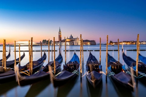 Venetian gondolas, boat dock at St Mark's Square, church of San Giorgio Maggiore in the background,