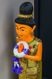 Figure with wreath of flowers at the entrance to the Thai massage parlour, Kaufbeuern, Allgaeu,
