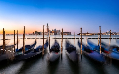 Venetian gondolas, boat dock at St Mark's Square, church of San Giorgio Maggiore in the background,