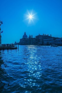 Silhouetted view of Grand canal with water taxis, Santa Maria della Salute basilica and Renaissance
