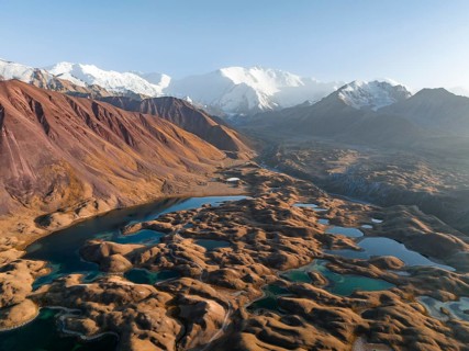 Aerial view, high mountain landscape with glacial moraines and mountain lakes, behind Pik Lenin,