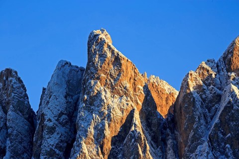 Mountain peaks illuminated by the setting sun with a clear blue sky, Italy, Trentino-Alto Adige,