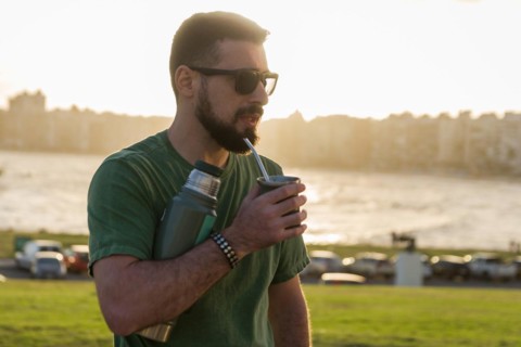 Man drinking chimarrao, mate tea tea (an infusion of yerba mate tea tea with hot water) at sunset