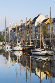 Moored sailboats and colourful 17th century apartment buildings and houses along the Nyhavn canal,