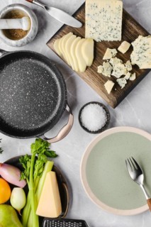 Top view of ingredients for risotto with pink rice, pear and blue cheese