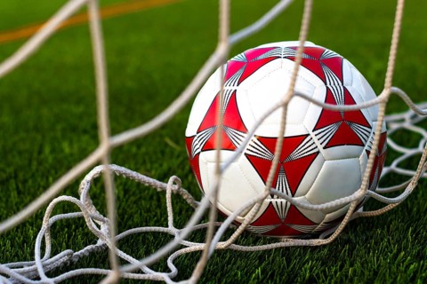 Close up of soccer ball inside the net field. Soccer ball inside the goal field. Football fever
