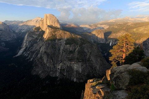 Warm evening light illuminates Half Dome and the surrounding cliffs of Yosemite, Yosemite National