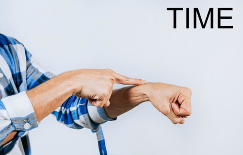 Person hand making TIME ASL American sign language. Hand making TIME gesture in sign language