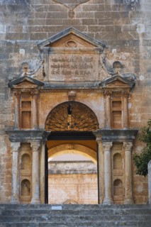 Stone steps and arched entrance with Doric columns at Holy Trinity (Agia Triada) Monastery,
