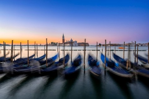 Venetian gondolas, boat dock at St Mark's Square, church of San Giorgio Maggiore in the background,