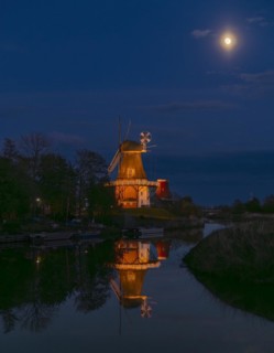 The Greetsiel Twin Mills at full moon, the Green Mill is reflected in the Old Greetsiel Deep,